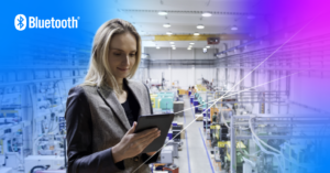 Professional woman using a tablet in a bright, modern industrial space with advanced technology.